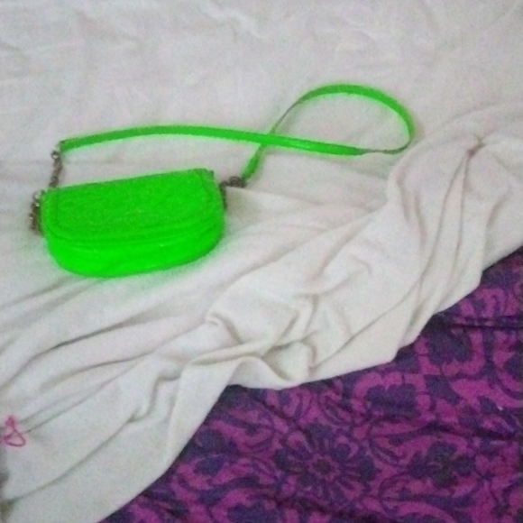 I'm am selling a black 14 /16 size black dress with a bow a hockey a green purse - Picture 5 of 5